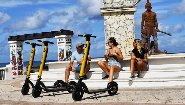 Photo of the tourists and their scooters