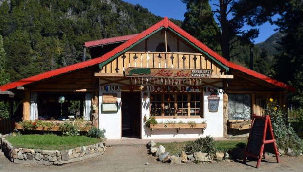 See the wooden house in Colonia Suiza