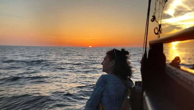 Admire a beautiful sunset on board