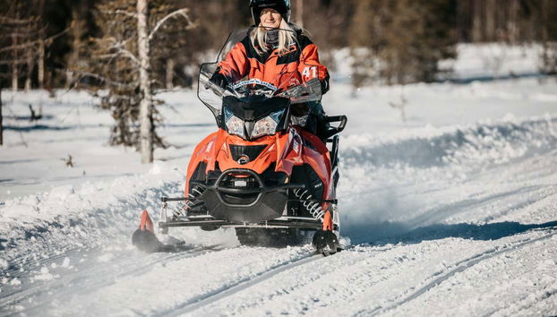Riding snowmobiles in Finland