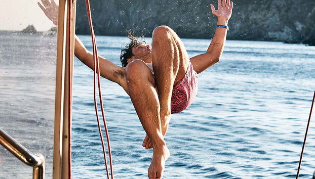 Daringly jumping off the boat