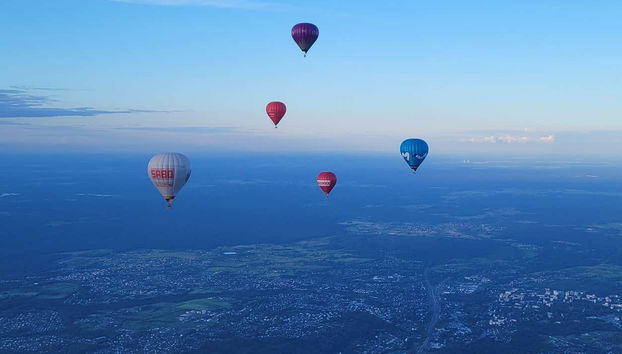 Hot air balloons flying over Trakai