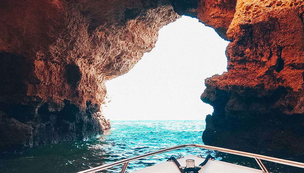 A boat leaving the cave