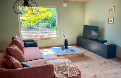 Amber Ferienhain - Ferienhaus 'Magnolie' mit verwunschenem Garten & privater Sauna - Foto 3