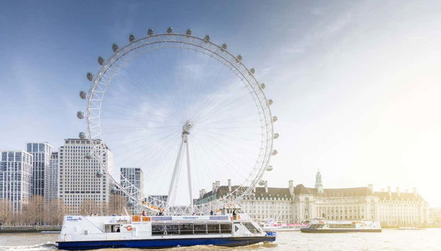 The boat passing the London Eye