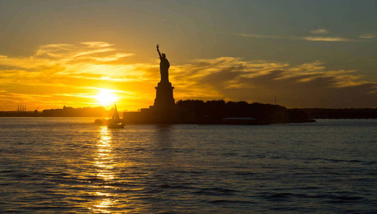 Admire the Statue of Liberty at sunset