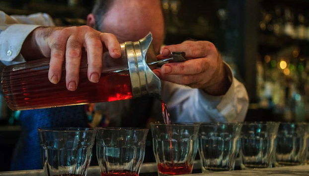 A bartender serving cocktails