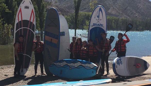 Having fun with friends while paddle surfing
