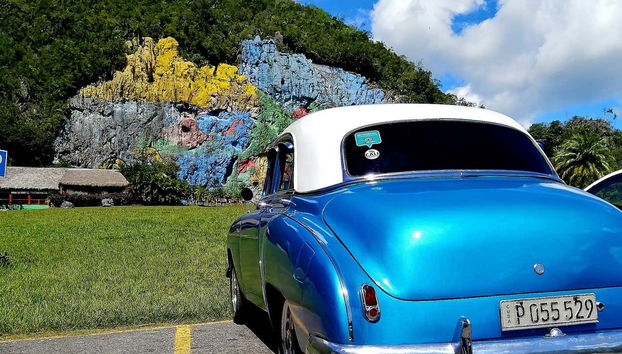 See the Prehistory Mural in Viñales Valley