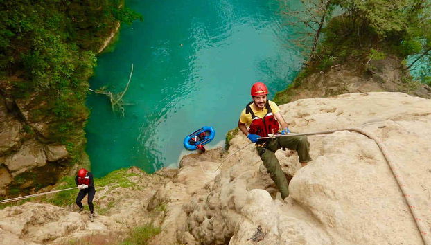 A group rappeling in the cavern