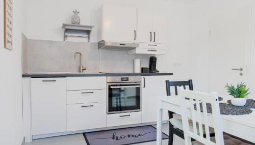 Untergeschoss mit Stil modern, ruhig & mit Terrasse - Foto 3, stove, dishwasher