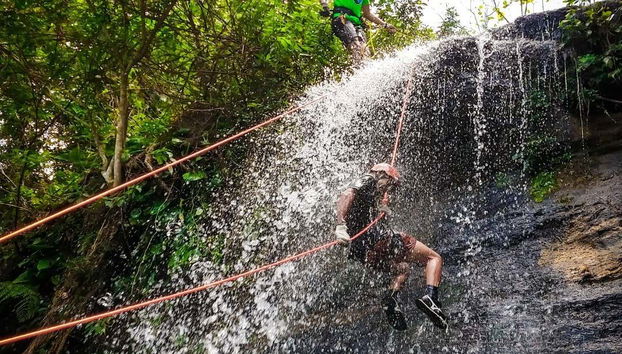Rappelling down a waterfall