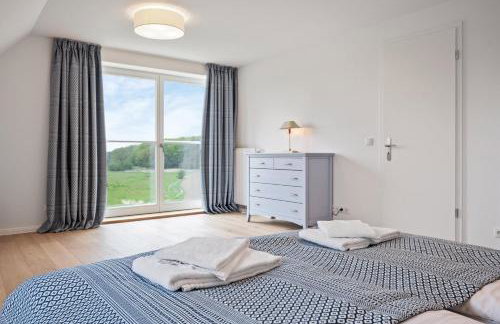 GUT KLETKAMP "Mühlenhof 5" - Ruhige Ferienwohnung mit 3 Schlafzimmern I Terrasse mit See- & Naturblick I Gemeinschaftsgarten I 15 Min zur Ostsee I Küche I Parkplatz I Waschmaschine I WLAN - Foto 6