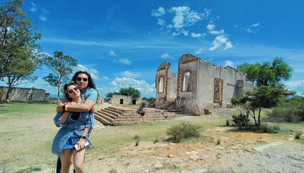 Couple avec vestiges d'une hacienda en arrière-plan