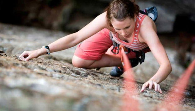 Climbing a mountain wall in Suesca