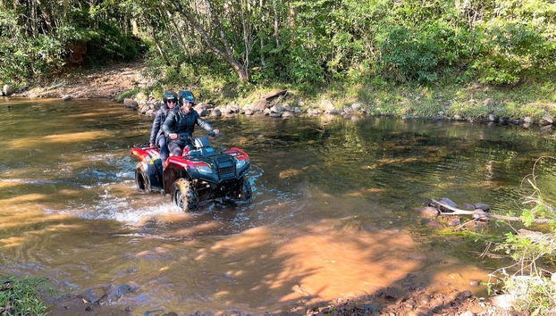 Quad biking on a river in Praia Grande